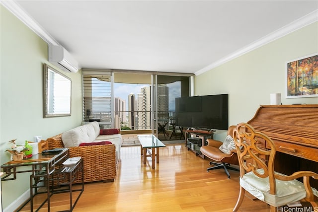 living room featuring a wall unit AC, light hardwood / wood-style flooring, and ornamental molding