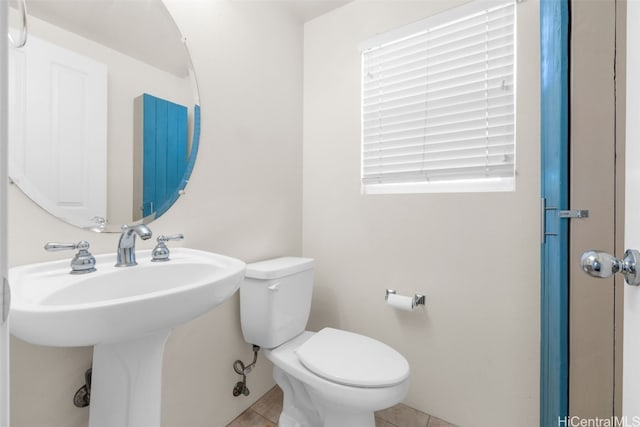 bathroom featuring toilet and tile patterned floors