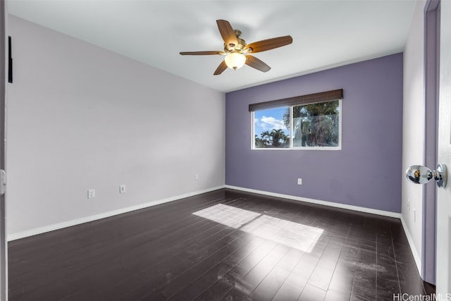 spare room with ceiling fan and dark hardwood / wood-style floors