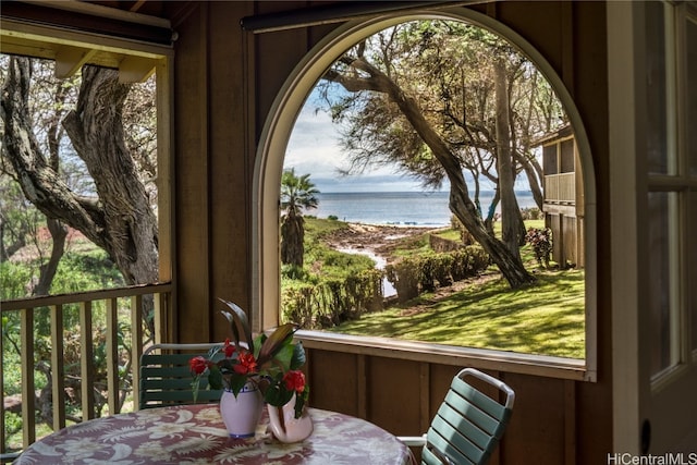 sunroom / solarium with a water view