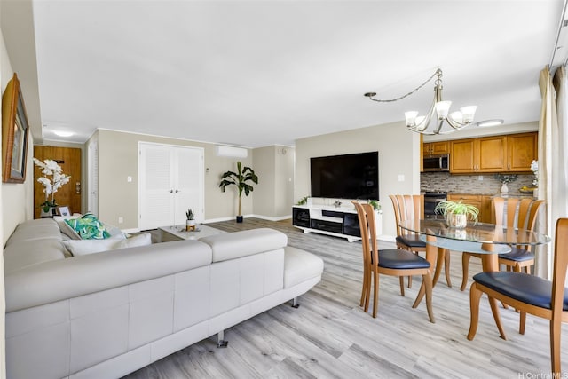 2724 Kahoaloha Ln Unit 1007, Honolulu, HI 96826 - living area featuring a chandelier, light wood-style flooring, and baseboards
