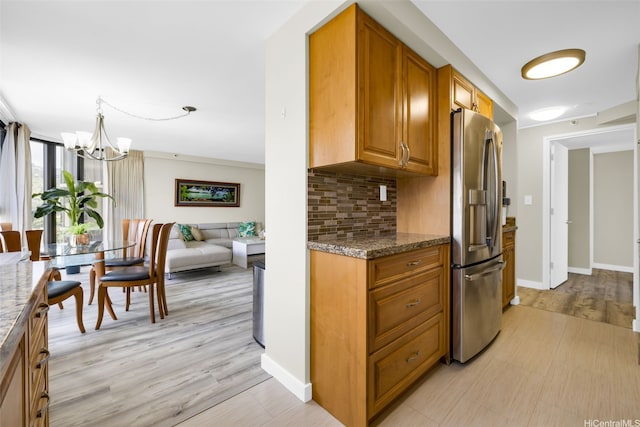 2724 Kahoaloha Ln Unit 1007, Honolulu, HI 96826 - kitchen featuring stainless steel refrigerator with ice dispenser, backsplash, brown cabinets, and a chandelier