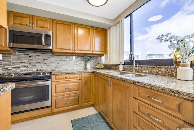 2724 Kahoaloha Ln Unit 1007, Honolulu, HI 96826 - kitchen with stainless steel appliances, a sink, light stone counters, and plenty of natural light