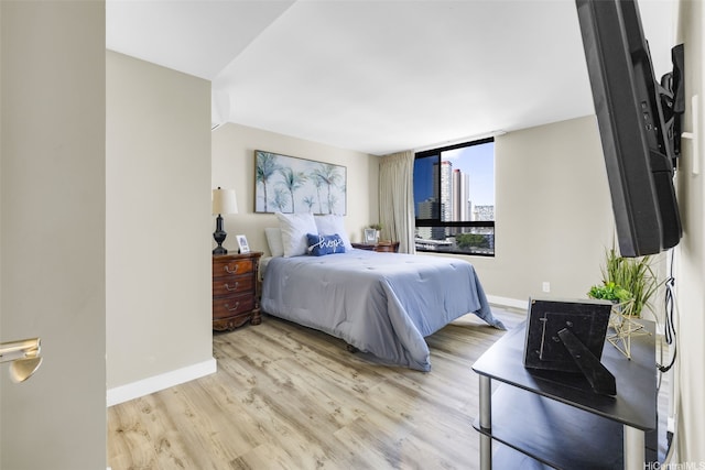 2724 Kahoaloha Ln Unit 1007, Honolulu, HI 96826 - bedroom featuring light wood-style flooring and baseboards