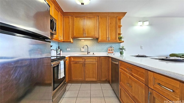 kitchen featuring light tile patterned flooring, sink, appliances with stainless steel finishes, light stone countertops, and decorative backsplash