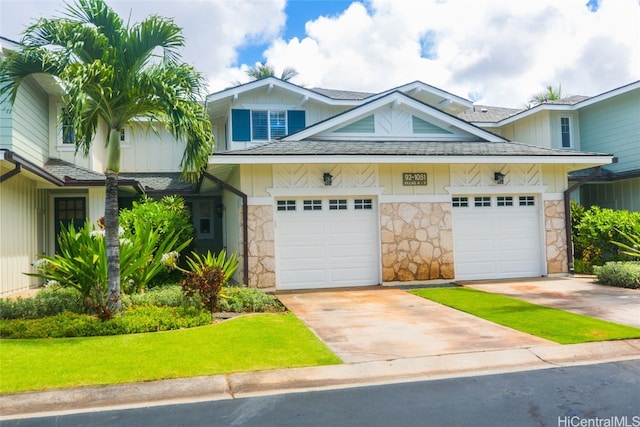 view of front facade with a front yard and a garage