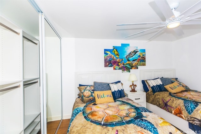 bedroom with wood-type flooring and ceiling fan