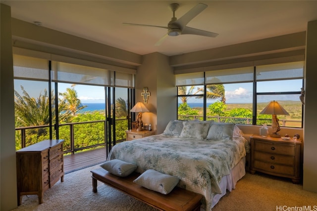 bedroom featuring light carpet, access to outside, and ceiling fan