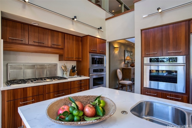 kitchen with stainless steel appliances and light stone counters