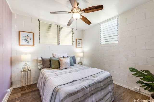 bedroom with dark hardwood / wood-style flooring and ceiling fan