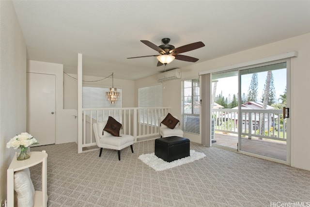 living area featuring ceiling fan with notable chandelier, a wall mounted AC, and light colored carpet