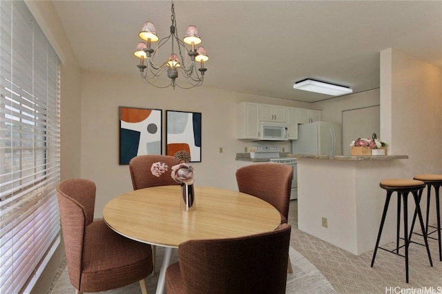 dining space with light colored carpet and an inviting chandelier