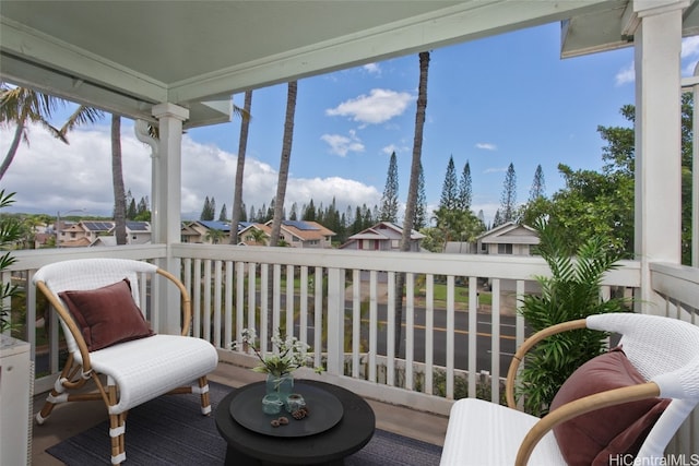 sunroom / solarium featuring a residential view