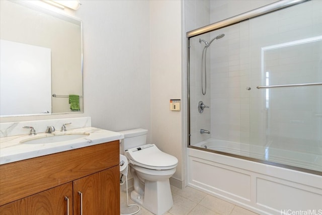 full bathroom with vanity, toilet, tile patterned flooring, and bath / shower combo with glass door