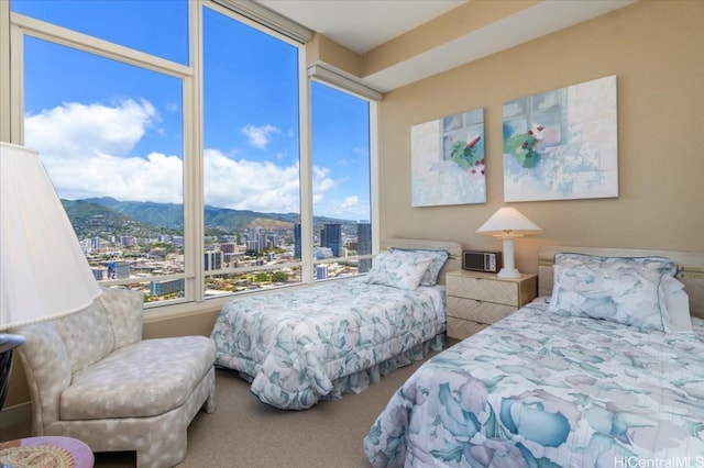 bedroom with a mountain view and carpet flooring