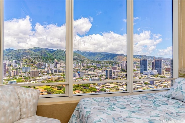 bedroom featuring a mountain view and multiple windows