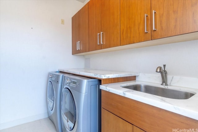 laundry room with sink, washer and dryer, cabinets, and light tile patterned floors