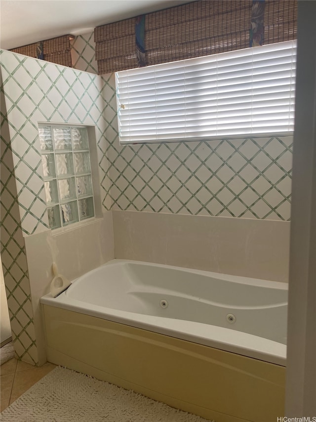 bathroom with a jetted tub and tile patterned floors