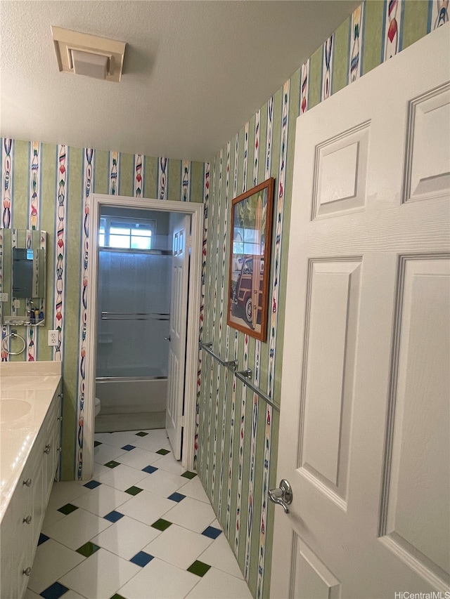 bathroom featuring wallpapered walls, vanity, toilet, tile patterned flooring, and visible vents