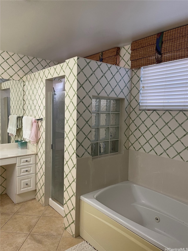 bathroom featuring vanity, a garden tub, tile patterned flooring, and a stall shower