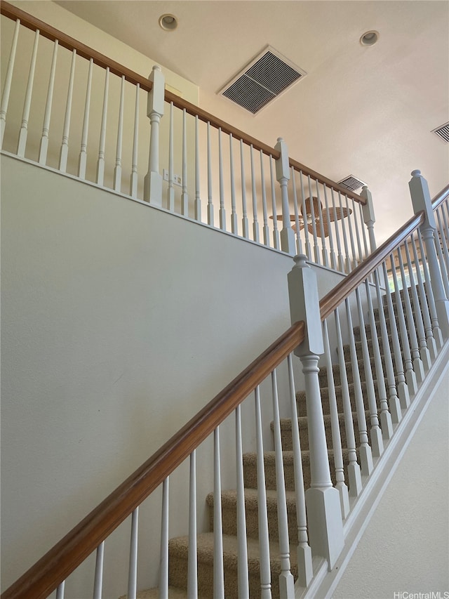 stairway with recessed lighting and visible vents