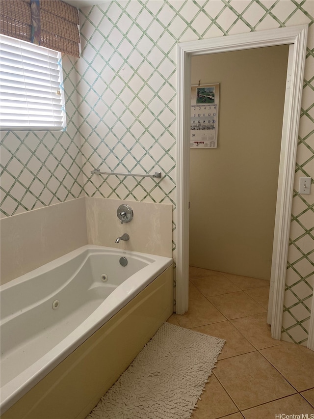 bathroom with tile patterned floors and a jetted tub