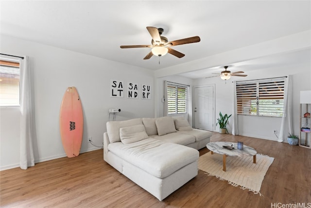 living room with ceiling fan, light hardwood / wood-style floors, and plenty of natural light