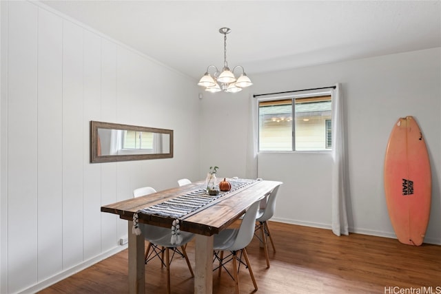 dining area featuring an inviting chandelier and hardwood / wood-style floors