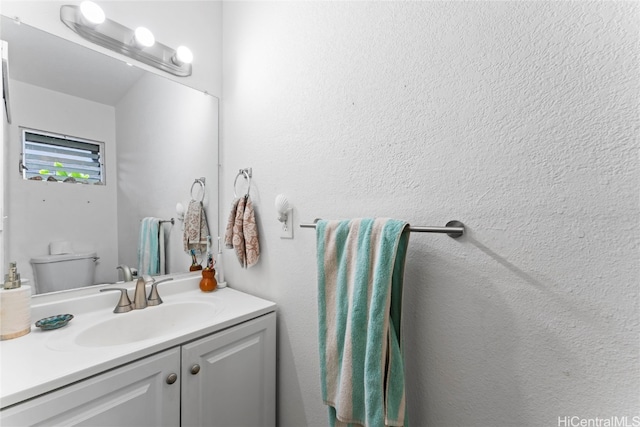 bathroom featuring toilet and vanity