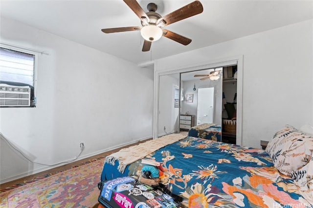 bedroom with a closet, ceiling fan, hardwood / wood-style flooring, and cooling unit