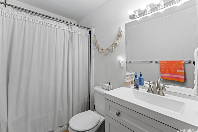 bathroom with vanity, a shower with shower curtain, and toilet