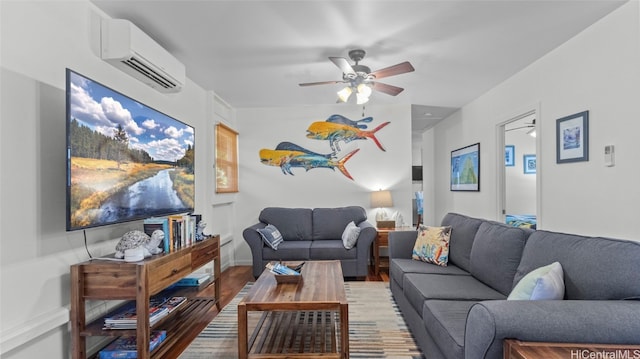 living room with a wall unit AC, hardwood / wood-style flooring, and ceiling fan