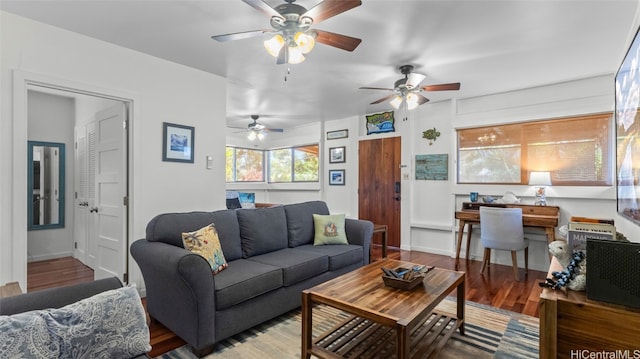 living room featuring wood-type flooring and ceiling fan