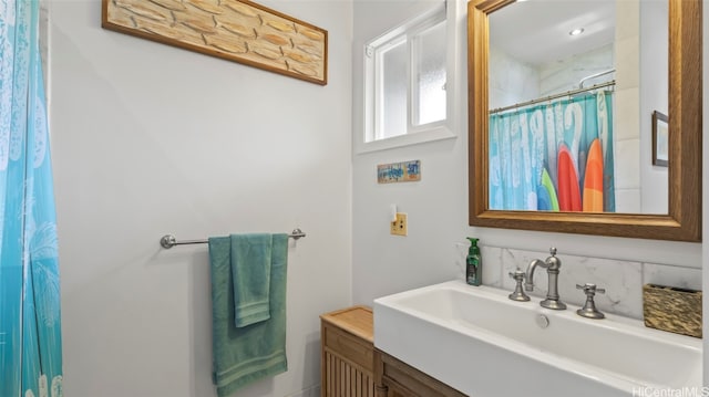 bathroom featuring vanity and curtained shower