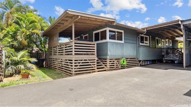 view of side of home with a carport