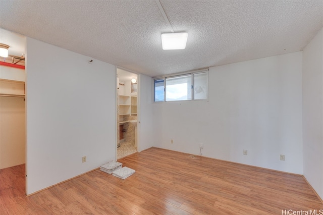 interior space featuring a textured ceiling and light wood-type flooring