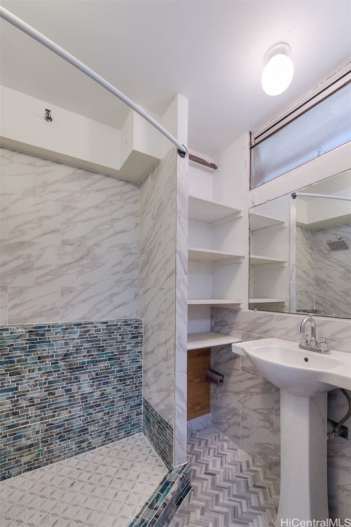 bathroom featuring tile walls, decorative backsplash, and tiled shower