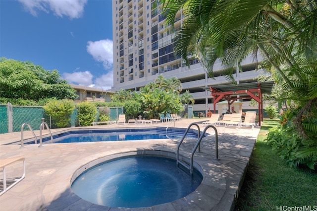 view of swimming pool featuring a patio area and a community hot tub