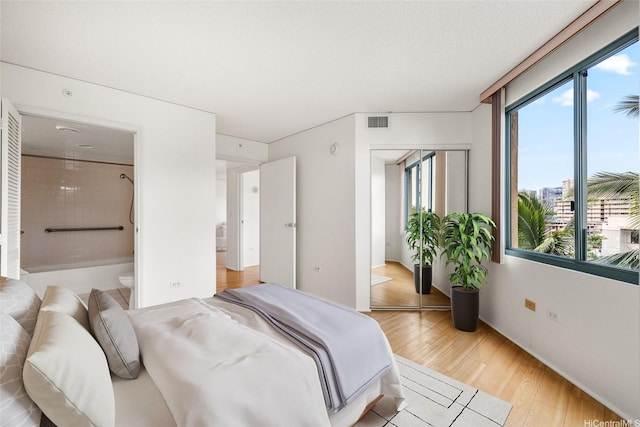 1314 Kalakaua Ave Unit 513, Honolulu, HI 96826 - bedroom featuring light wood-style flooring and connected bathroom