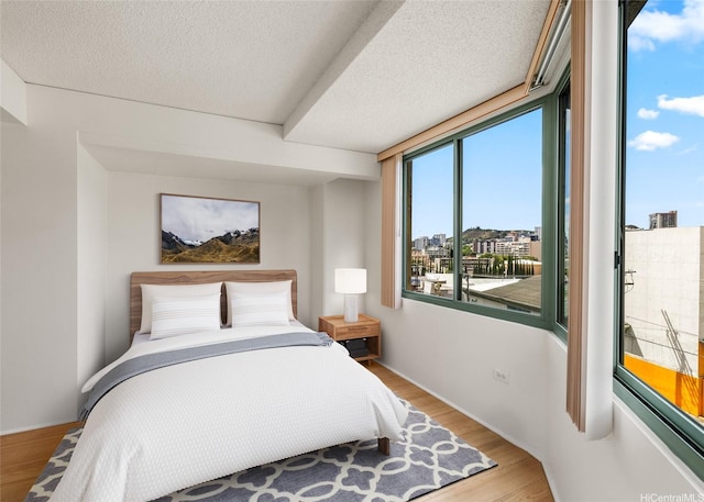 1314 Kalakaua Ave Unit 513, Honolulu, HI 96826 - bedroom featuring wood finished floors and a textured ceiling