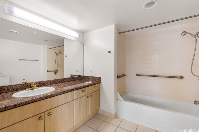 full bathroom with vanity, toilet, tile patterned floors, and tiled shower / bath combo