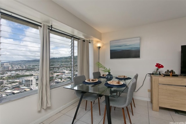 dining room featuring light tile patterned floors and baseboards