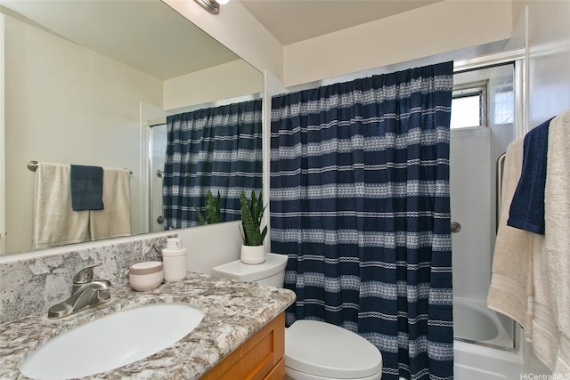 bathroom with vanity, shower / tub combo with curtain, and toilet