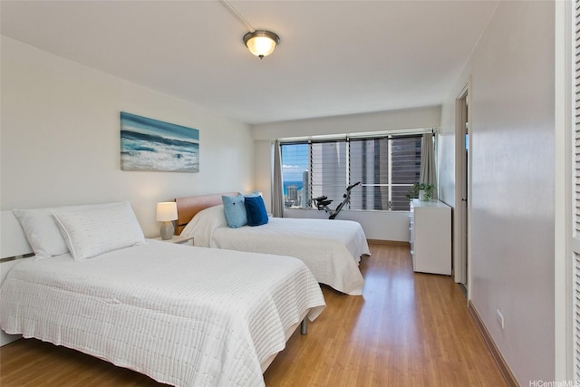 2525 Date St Unit 3706, Honolulu, HI 96826 - bedroom featuring wood finished floors and baseboards