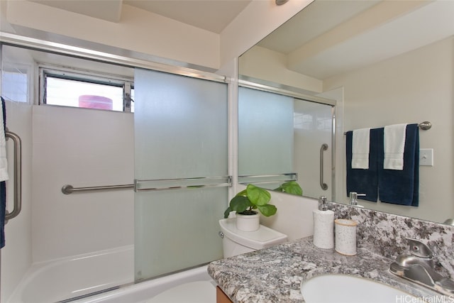 full bathroom with combined bath / shower with glass door, toilet, and vanity