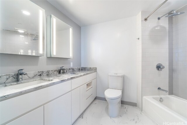 full bathroom with toilet, tiled shower / bath, and vanity