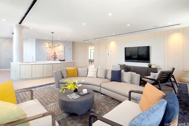 living room with sink and light hardwood / wood-style flooring