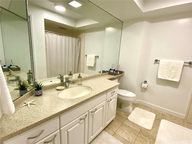 bathroom featuring vanity, tile patterned flooring, and toilet