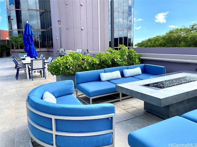 view of patio / terrace featuring an outdoor living space with a fire pit