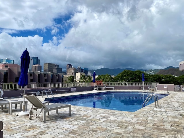 view of swimming pool featuring a mountain view and a patio area